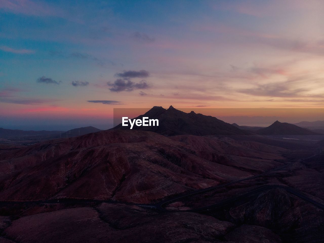 Scenic view of mountain against cloudy sky