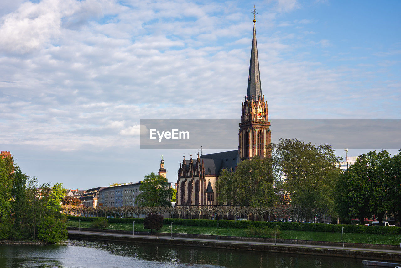 architecture, built structure, building exterior, water, reflection, sky, travel destinations, building, landmark, place of worship, tower, river, religion, nature, waterway, history, cloud, the past, travel, city, tourism, tree, belief, bridge, plant, cityscape, château, spire, spirituality, no people, business finance and industry, outdoors, blue, waterfront, day, worship, landscape, trip, holiday, old