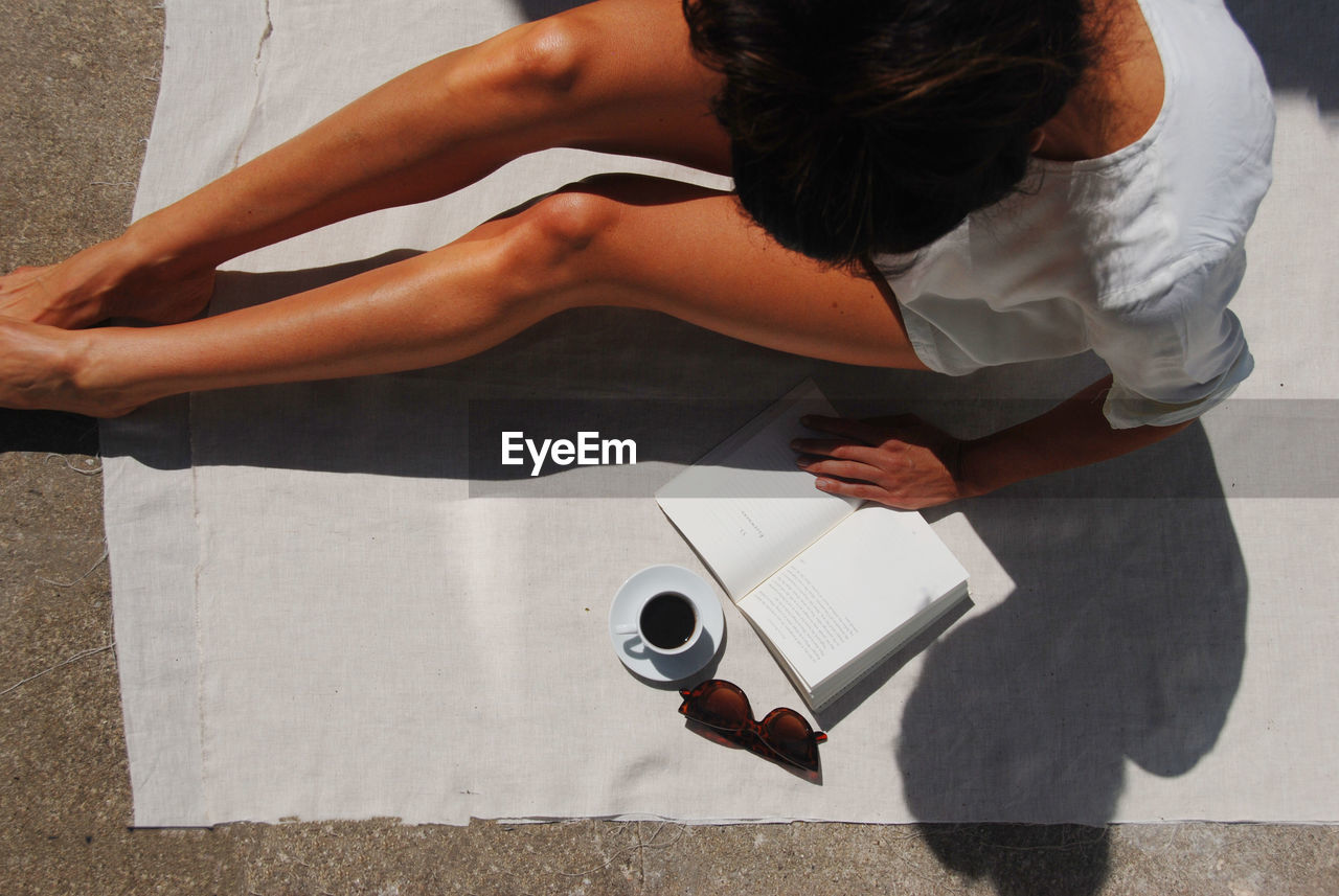 High angle view of woman holding coffee cup