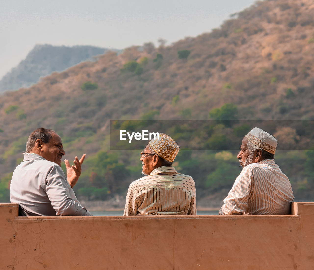 Rear view of people , three friends spending time with each other share their experiences of life 