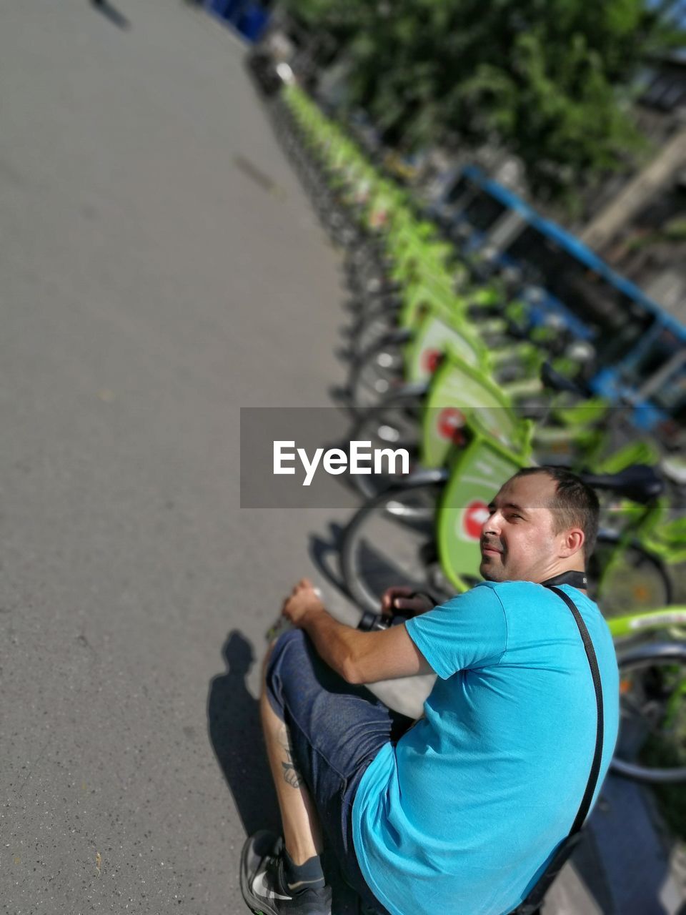 MAN RIDING BICYCLE ON A ROAD