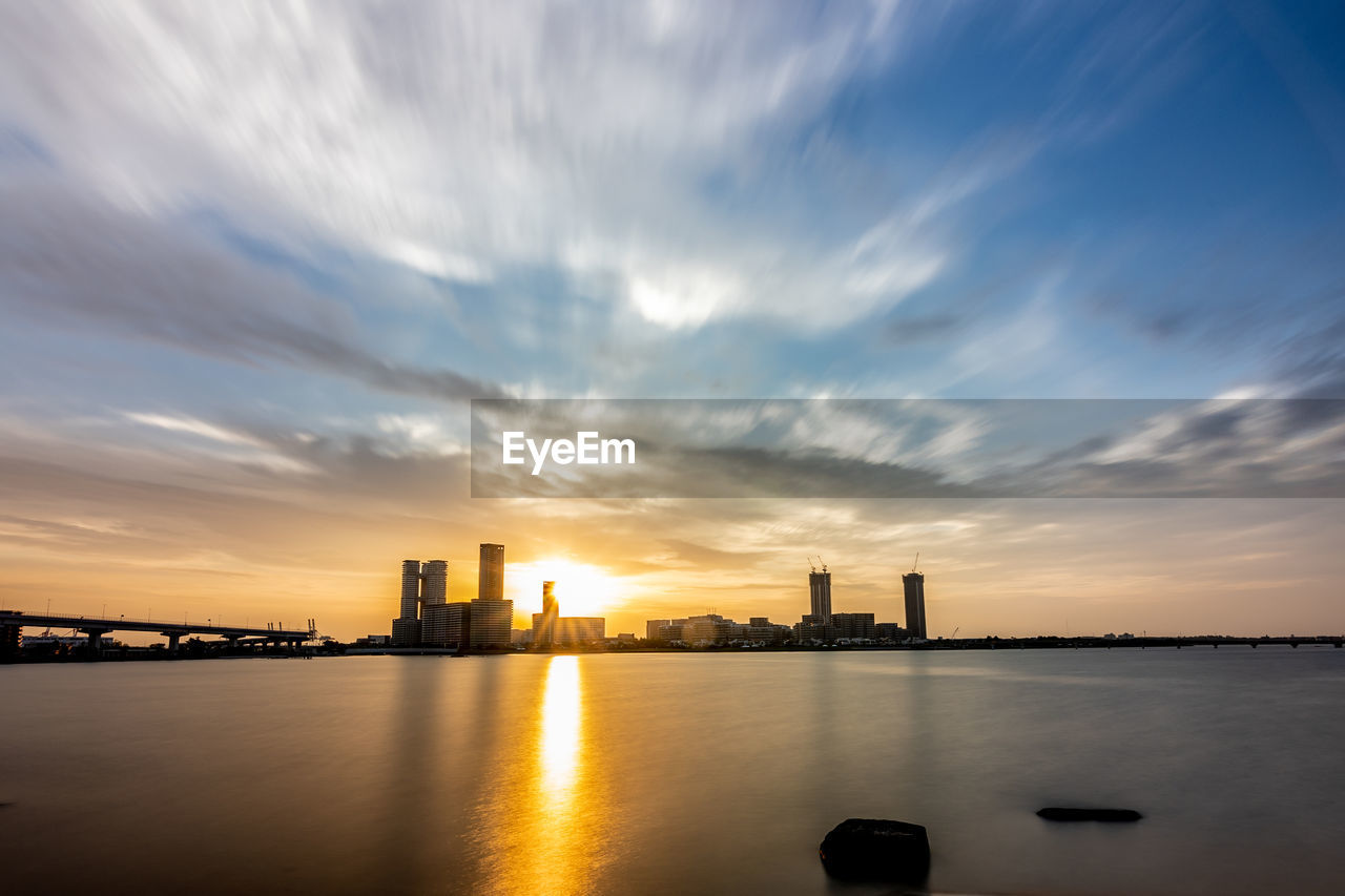 SCENIC VIEW OF RIVER BY BUILDINGS AGAINST SKY