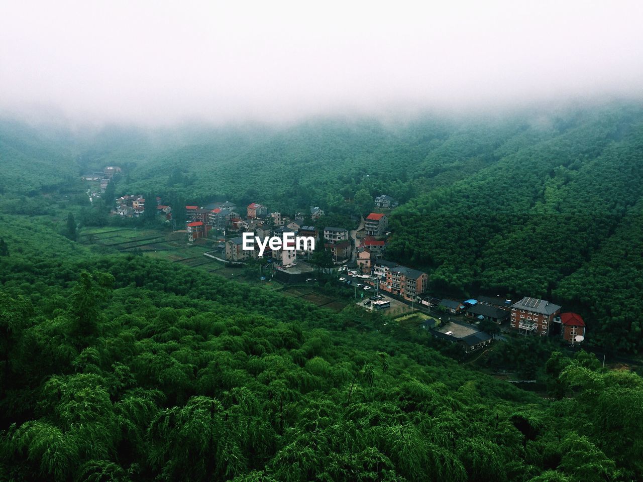 High angle view of green landscape against sky