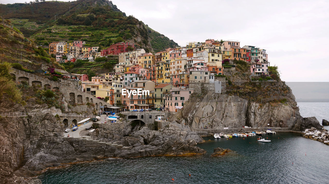 Scenic view of sea by cliff against sky