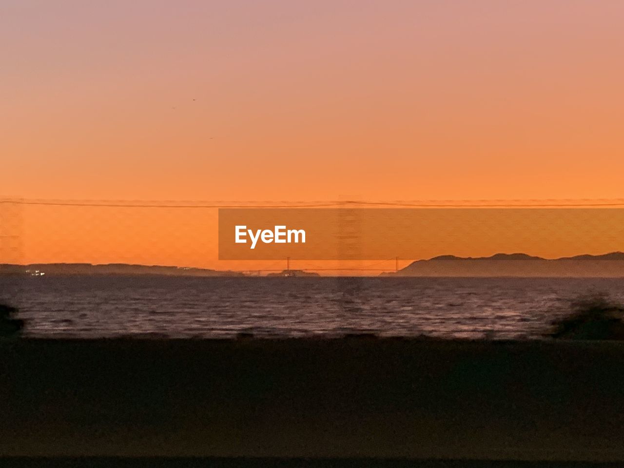 SCENIC VIEW OF BEACH DURING SUNSET