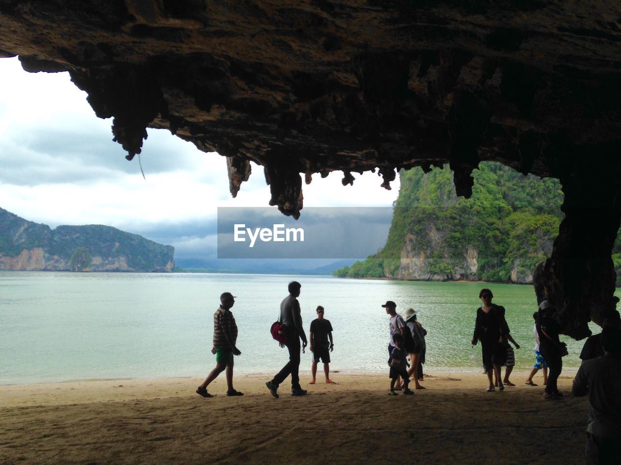 Group of people by cave at beach