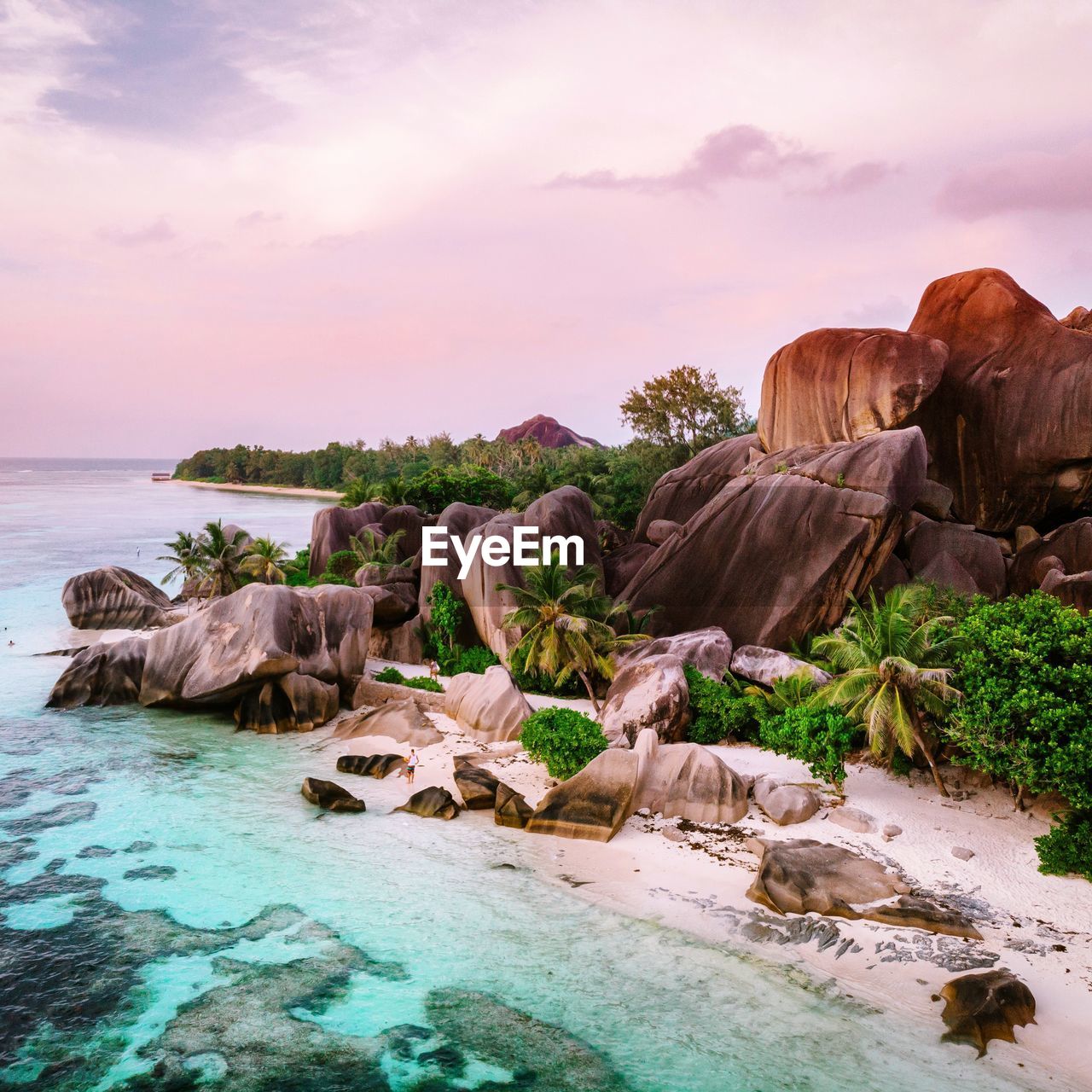 Rocks on sea shore against sky during sunset, seychelles tropical island 