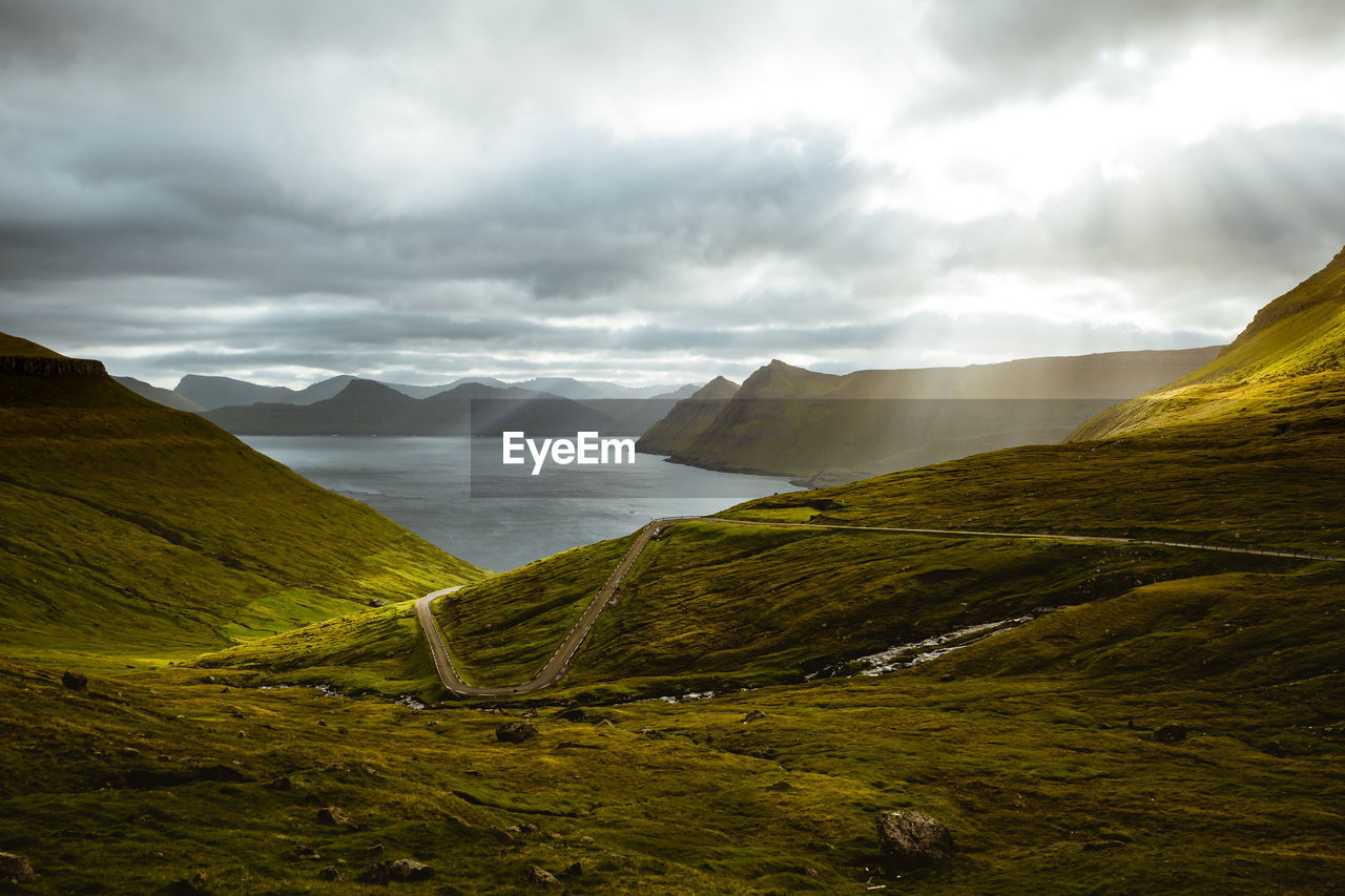 Scenic view of mountains against cloudy sky