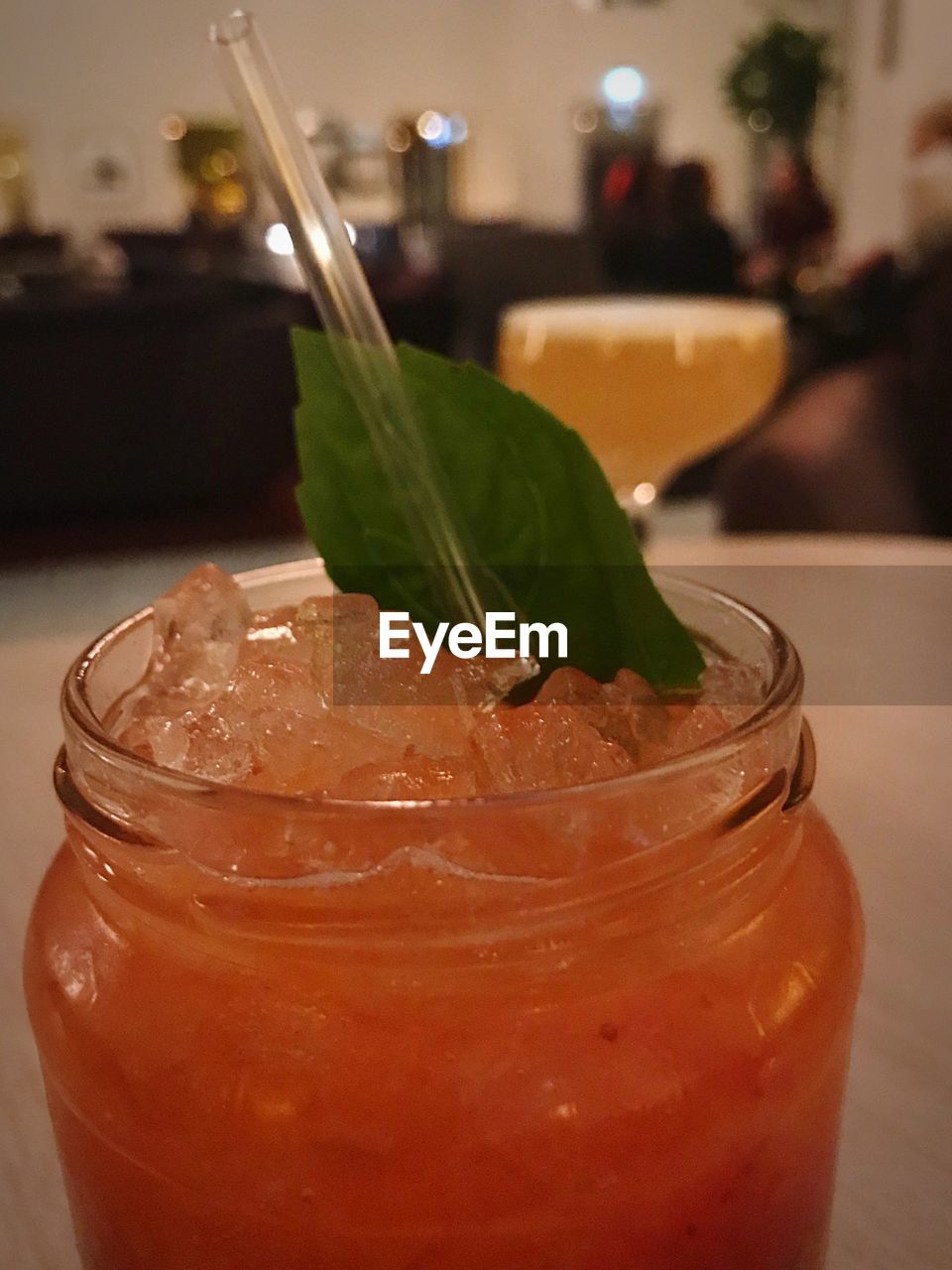 CLOSE-UP OF JUICE IN JAR ON TABLE