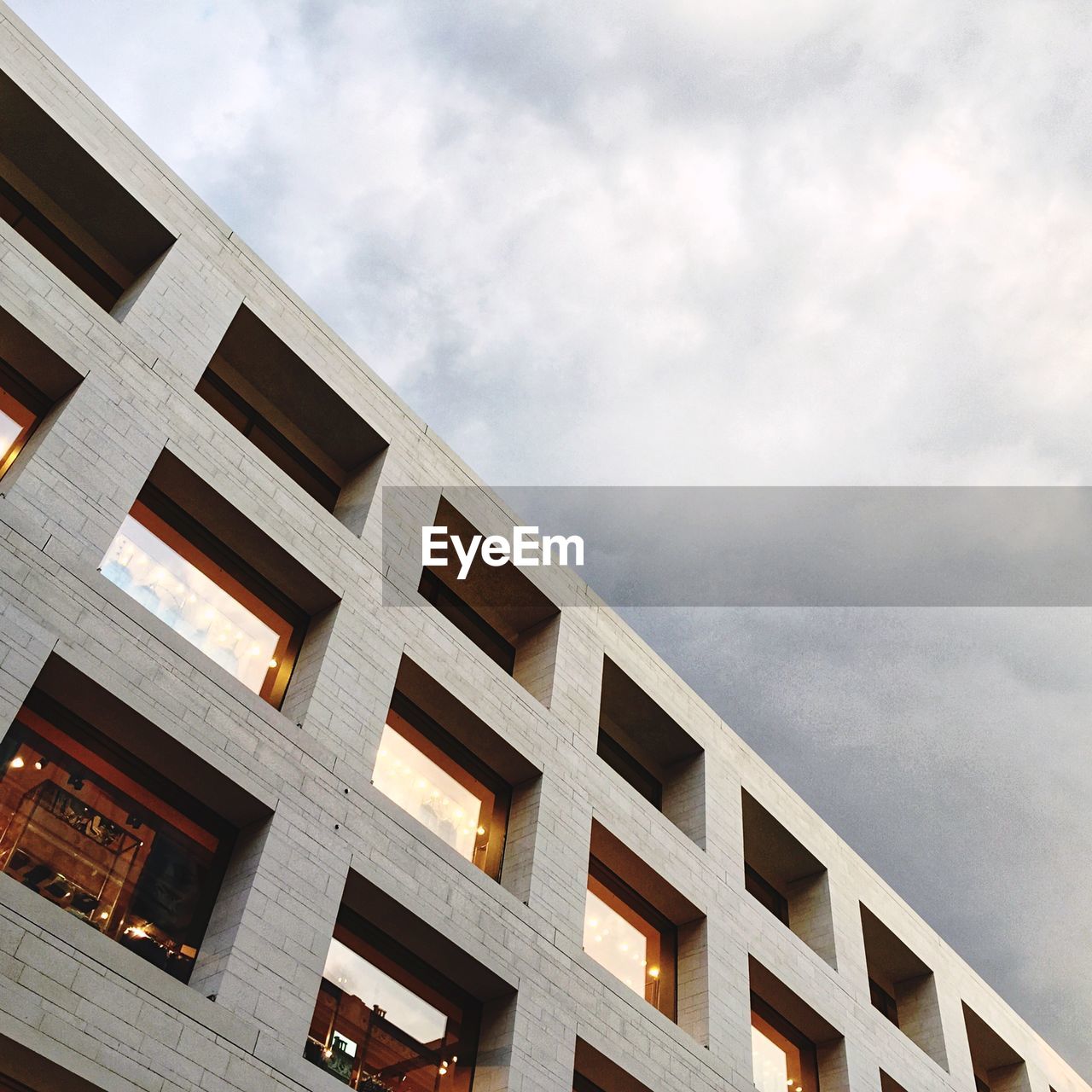 Low angle view of building against cloudy sky