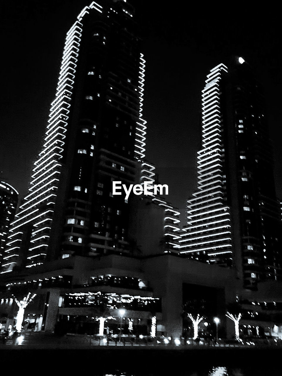 LOW ANGLE VIEW OF ILLUMINATED BUILDINGS AGAINST SKY