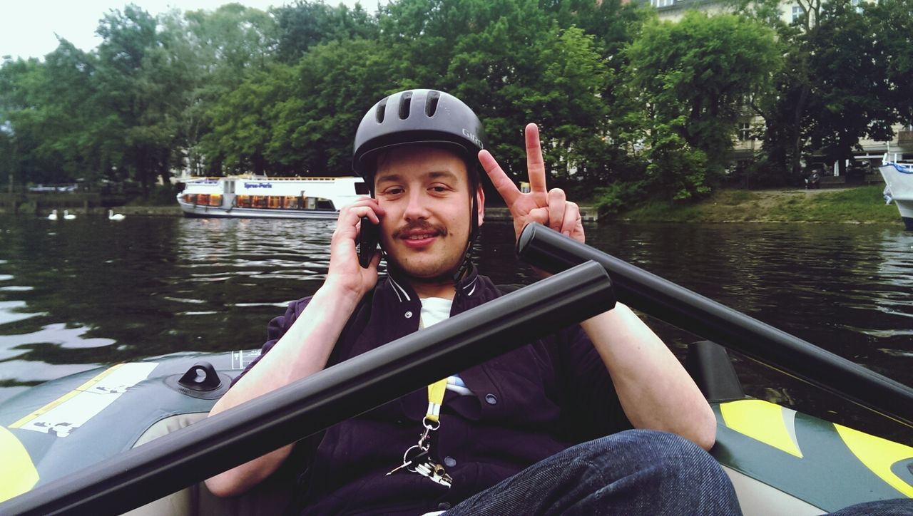 Man talking on mobile phone in inflatable raft