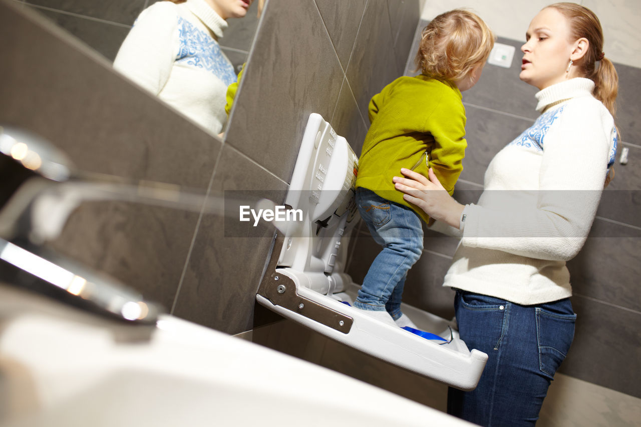 Mother and son in bathroom at home