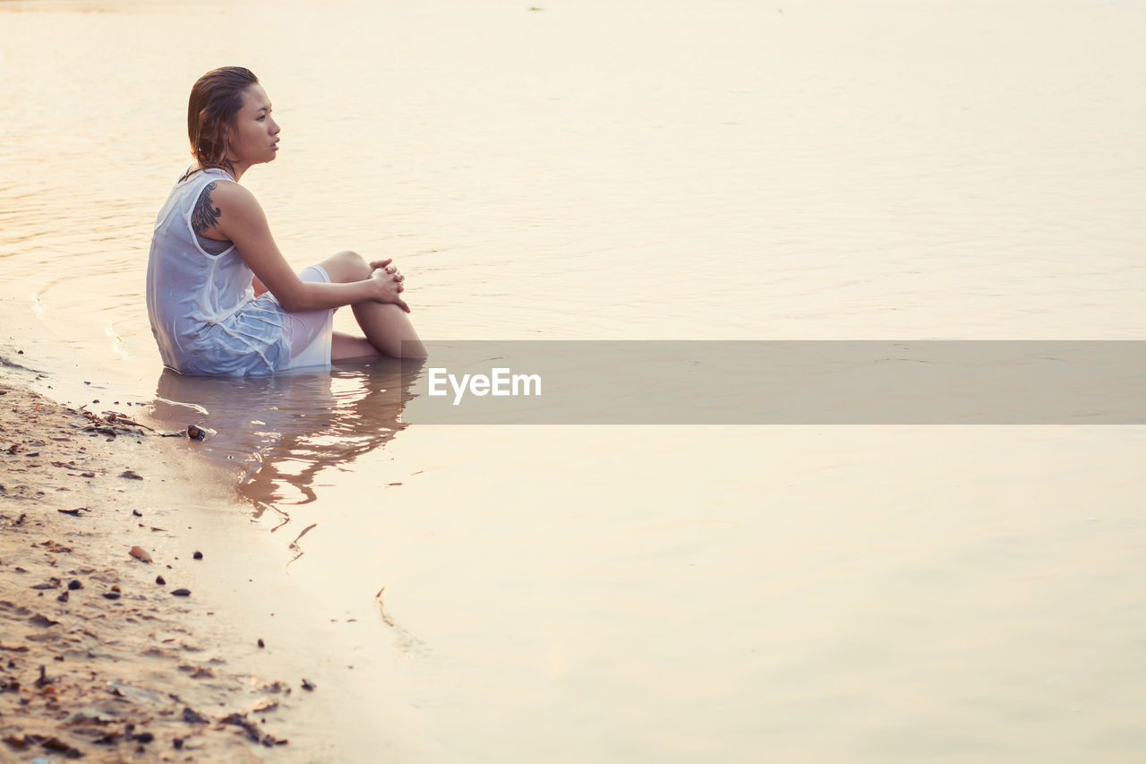 Woman sitting in sea