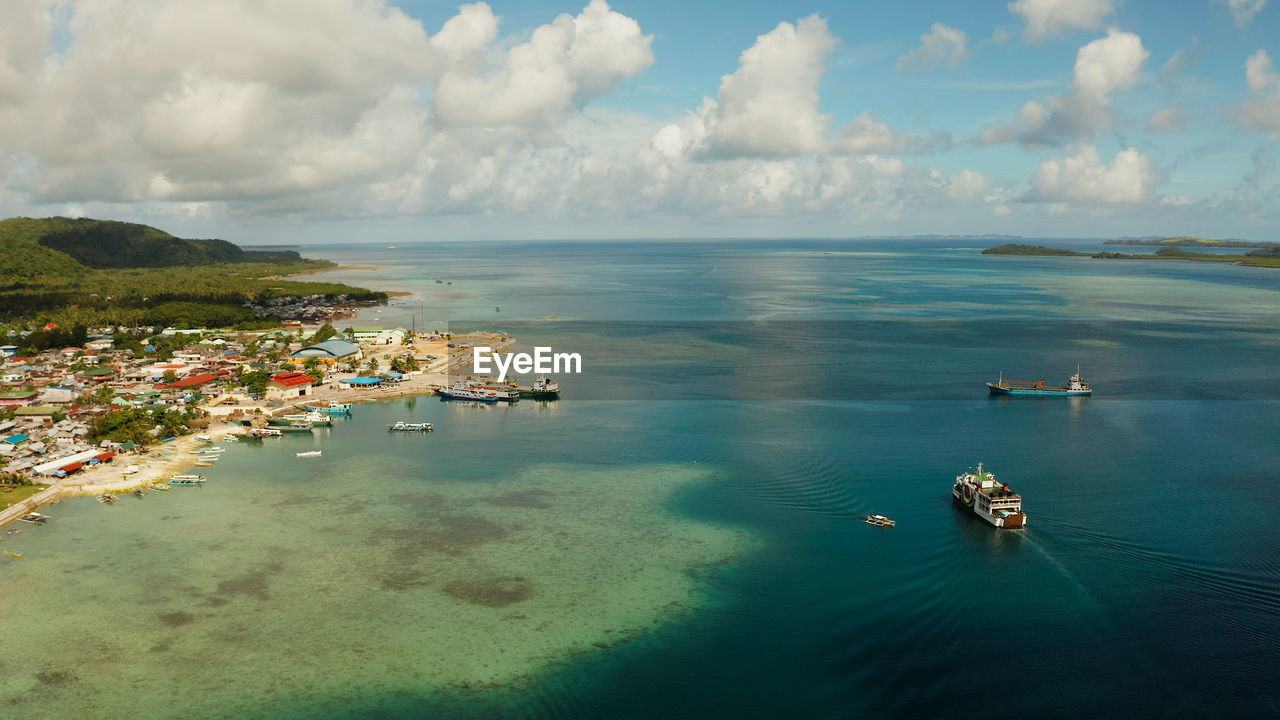 Passenger port with ferries and cargo ships on the island of siargao. dapa ferry terminal