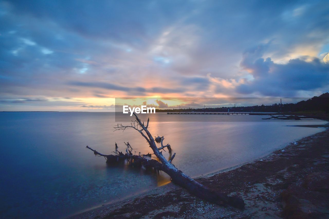 Scenic view of sea against sky at sunset