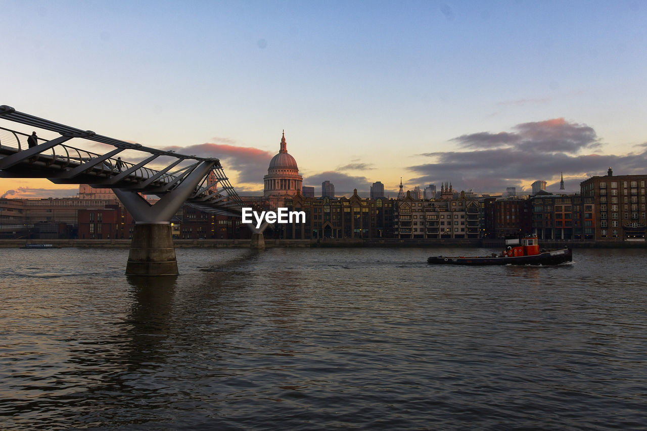 VIEW OF RIVER WITH BUILDINGS IN BACKGROUND