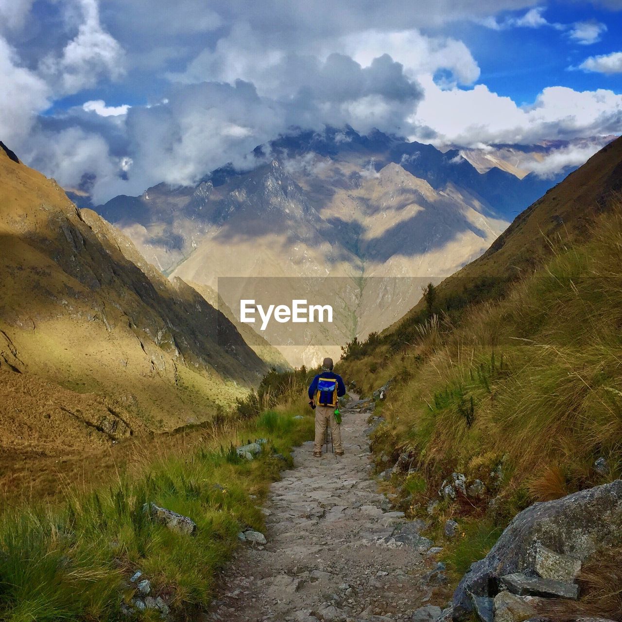 Rear view of woman standing on mountain landscape