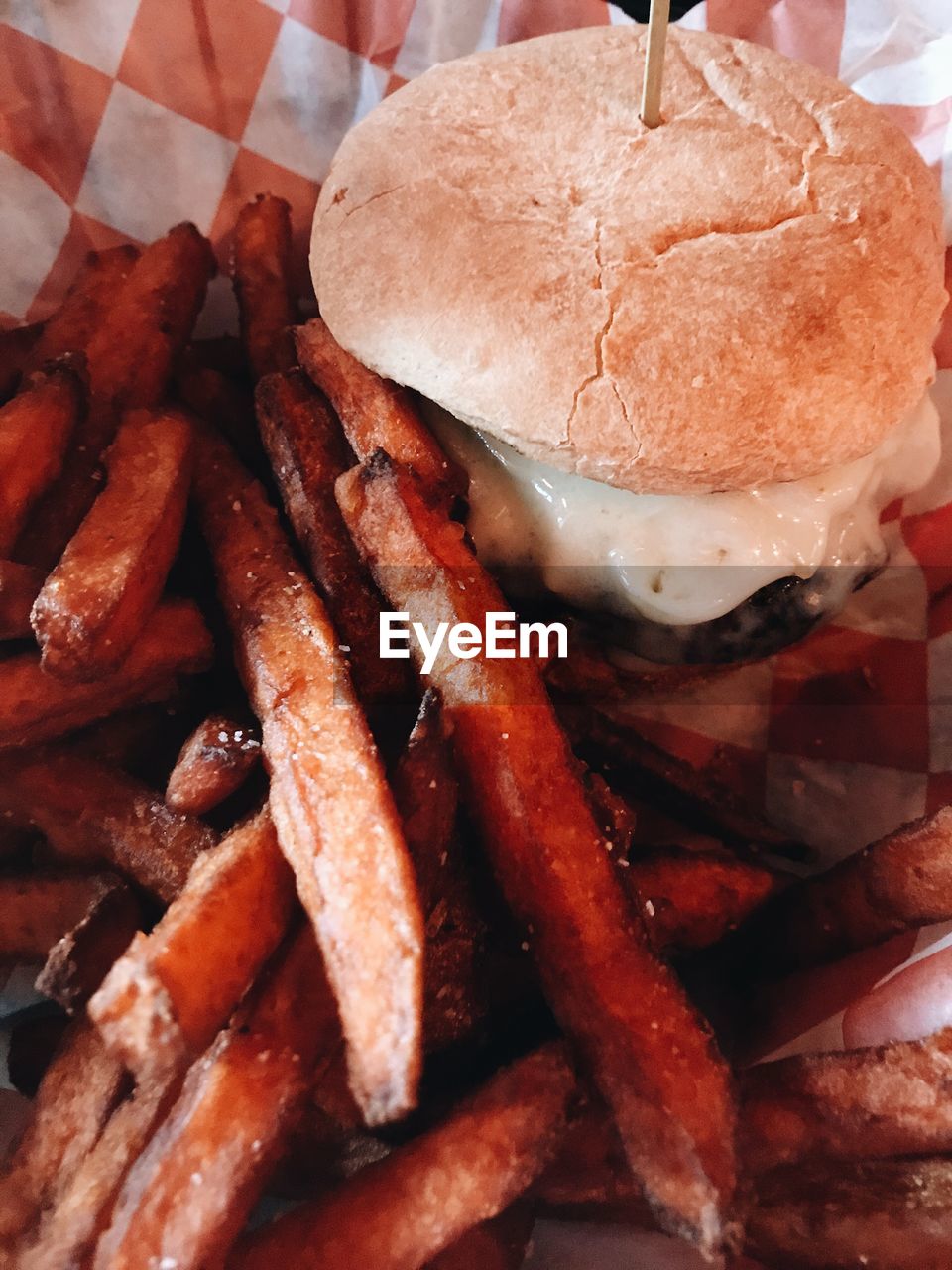 High angle view of hamburger and fresh fries in container 