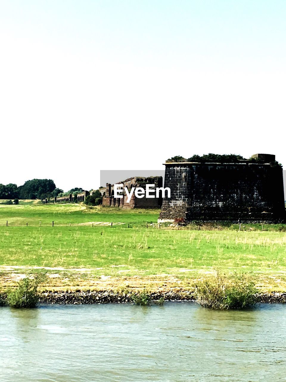 VIEW OF BUILT STRUCTURE ON GRASSY FIELD