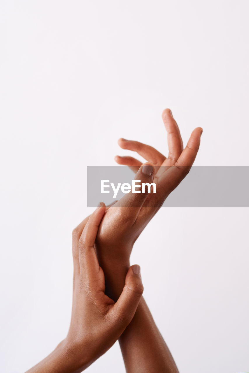 close-up of human hands against white background