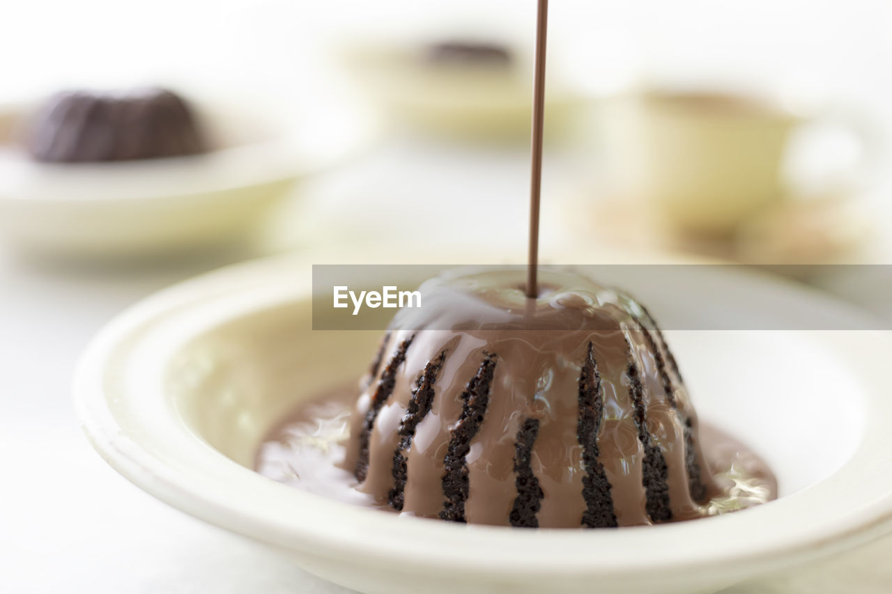 Hot chocolate poured in chocolate cake