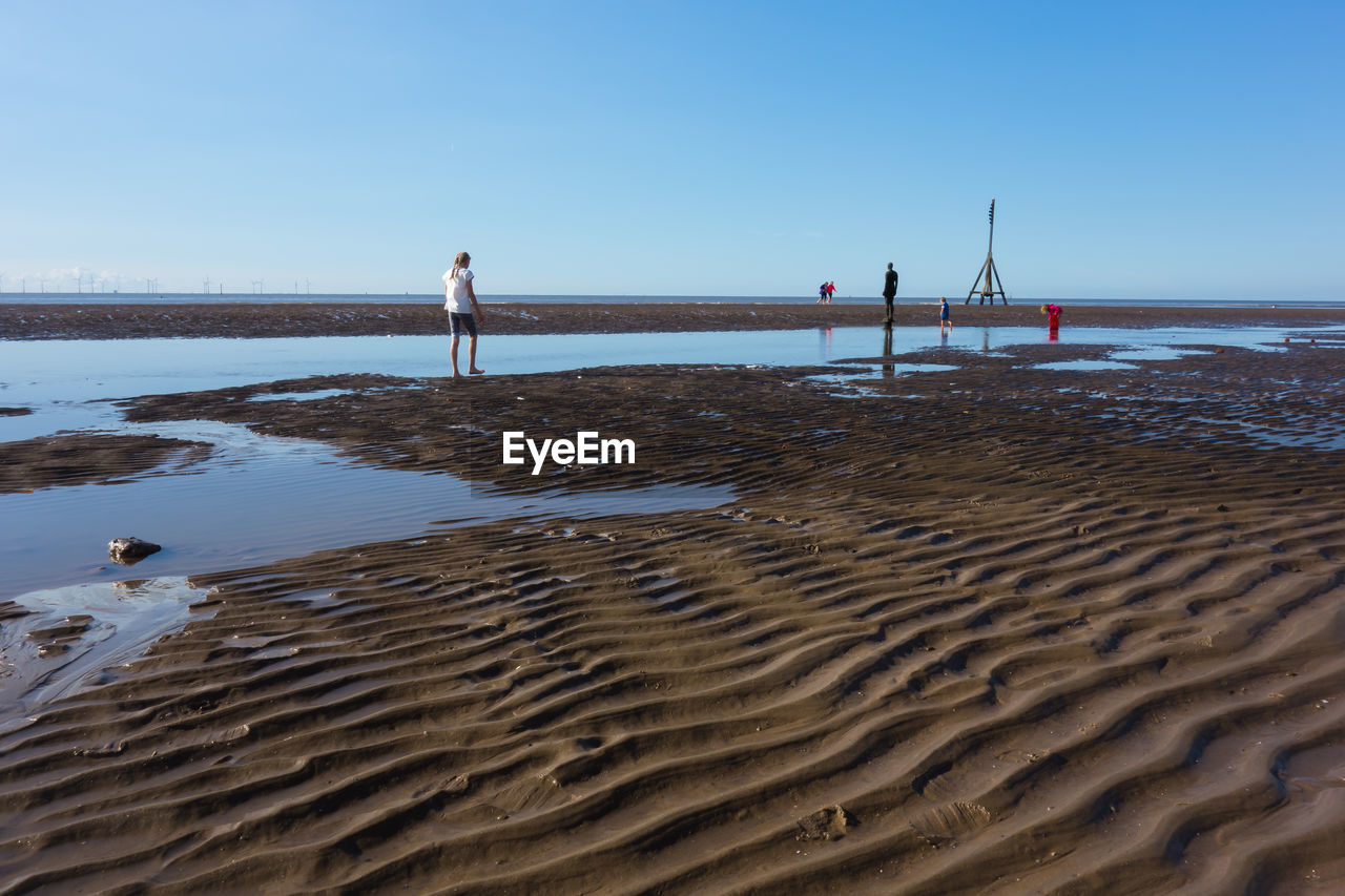 PIER OVER SEA AGAINST CLEAR BLUE SKY