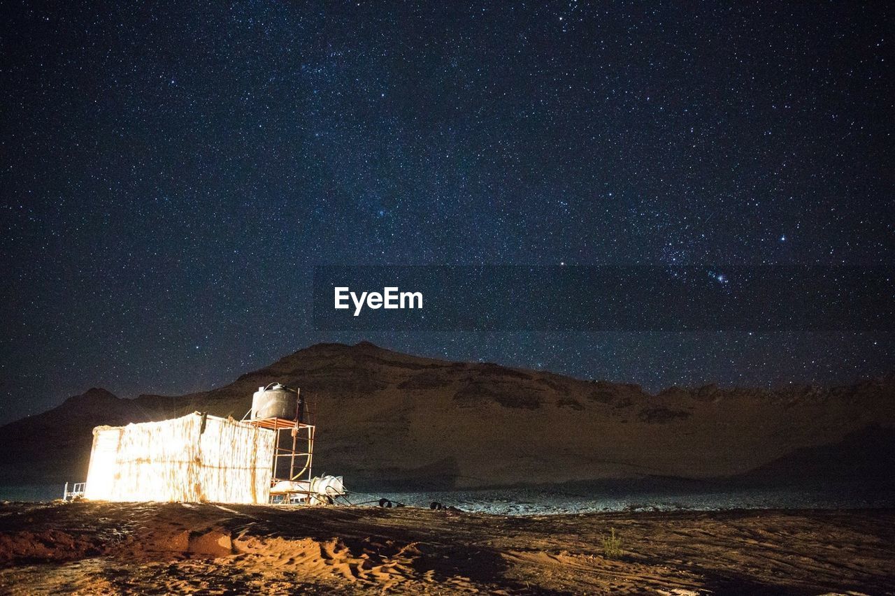 Scenic view of mountains against sky at night