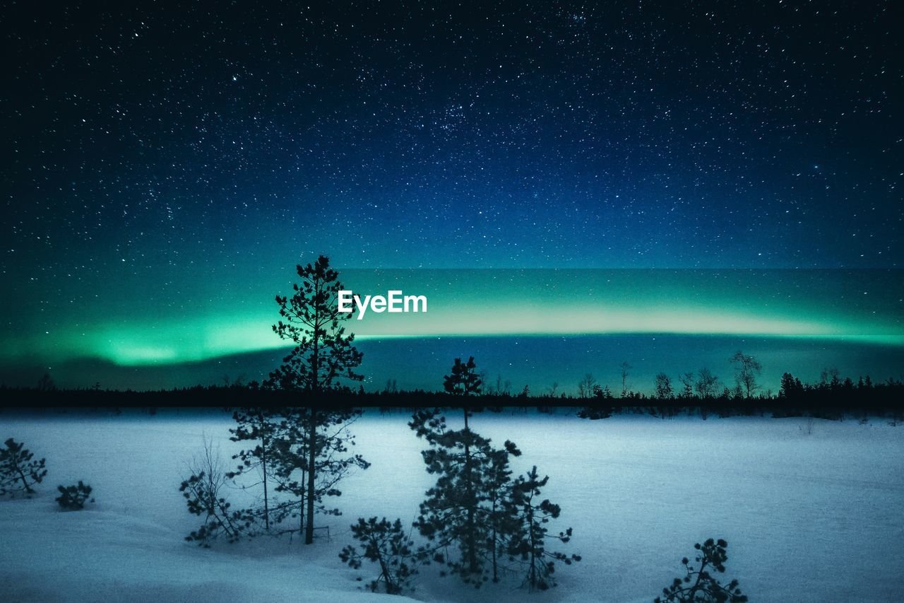 Scenic view of lake against sky at night