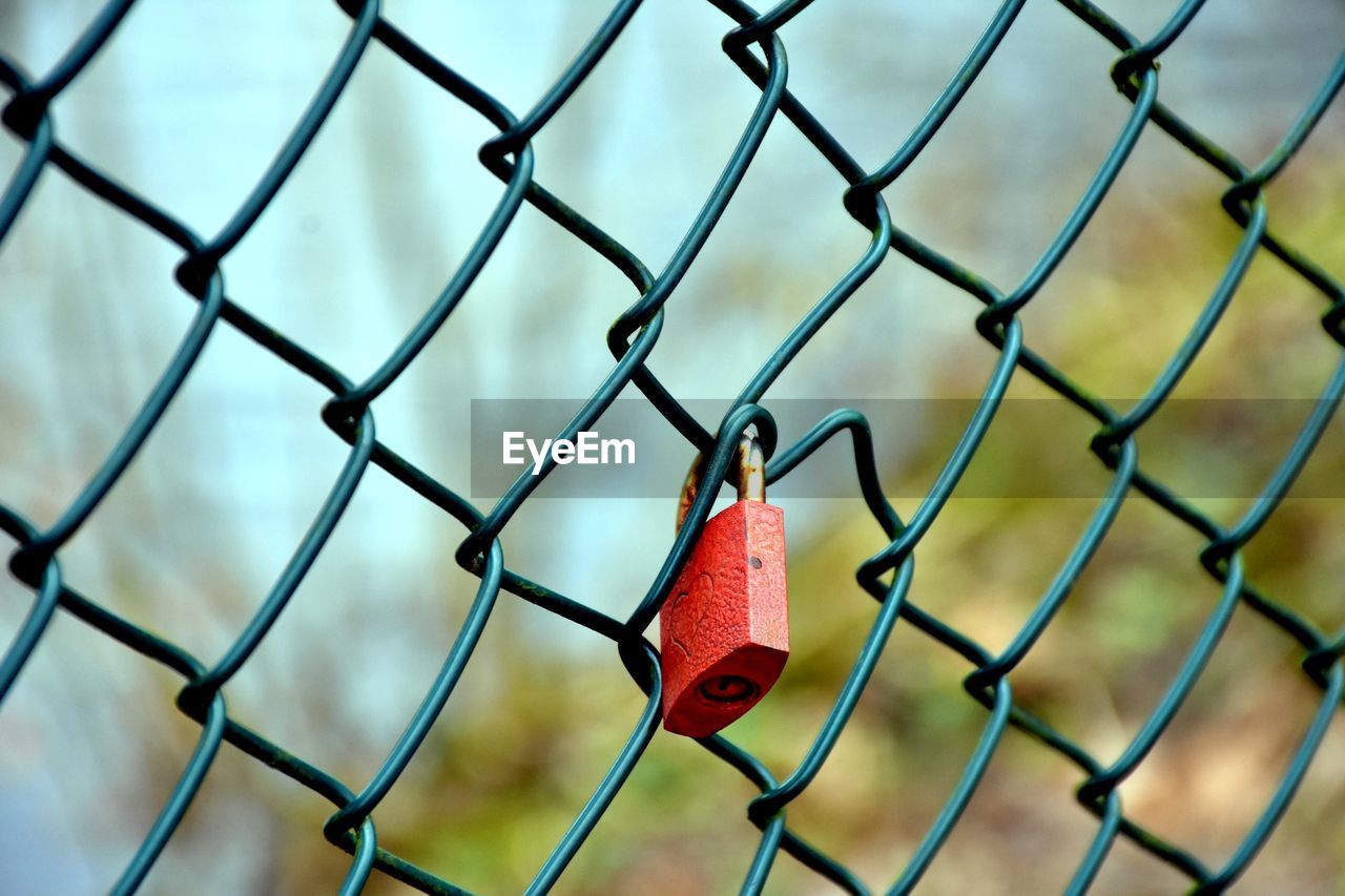 Close-up of padlock on chainlink fence