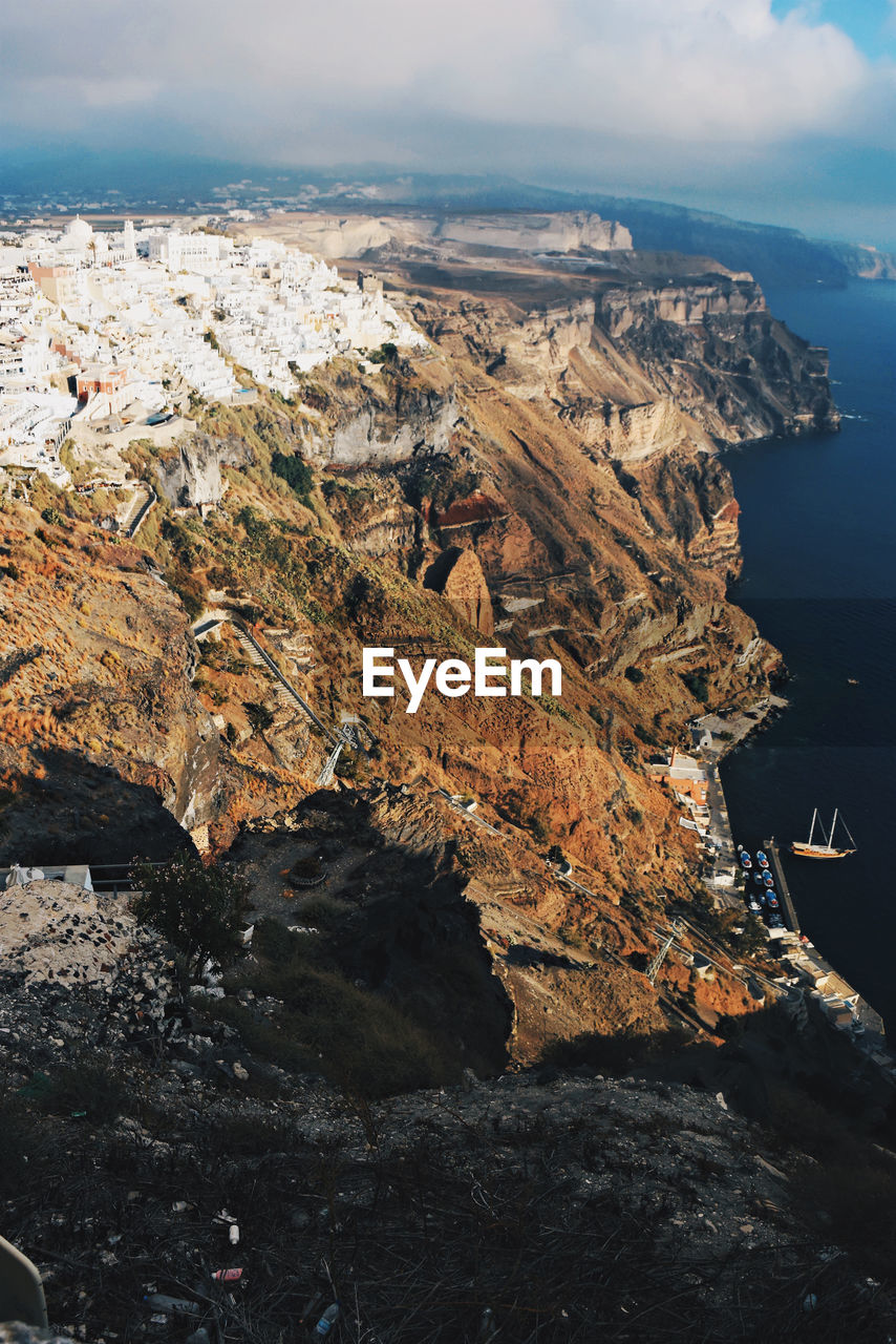 High angle view of rocks by sea against sky