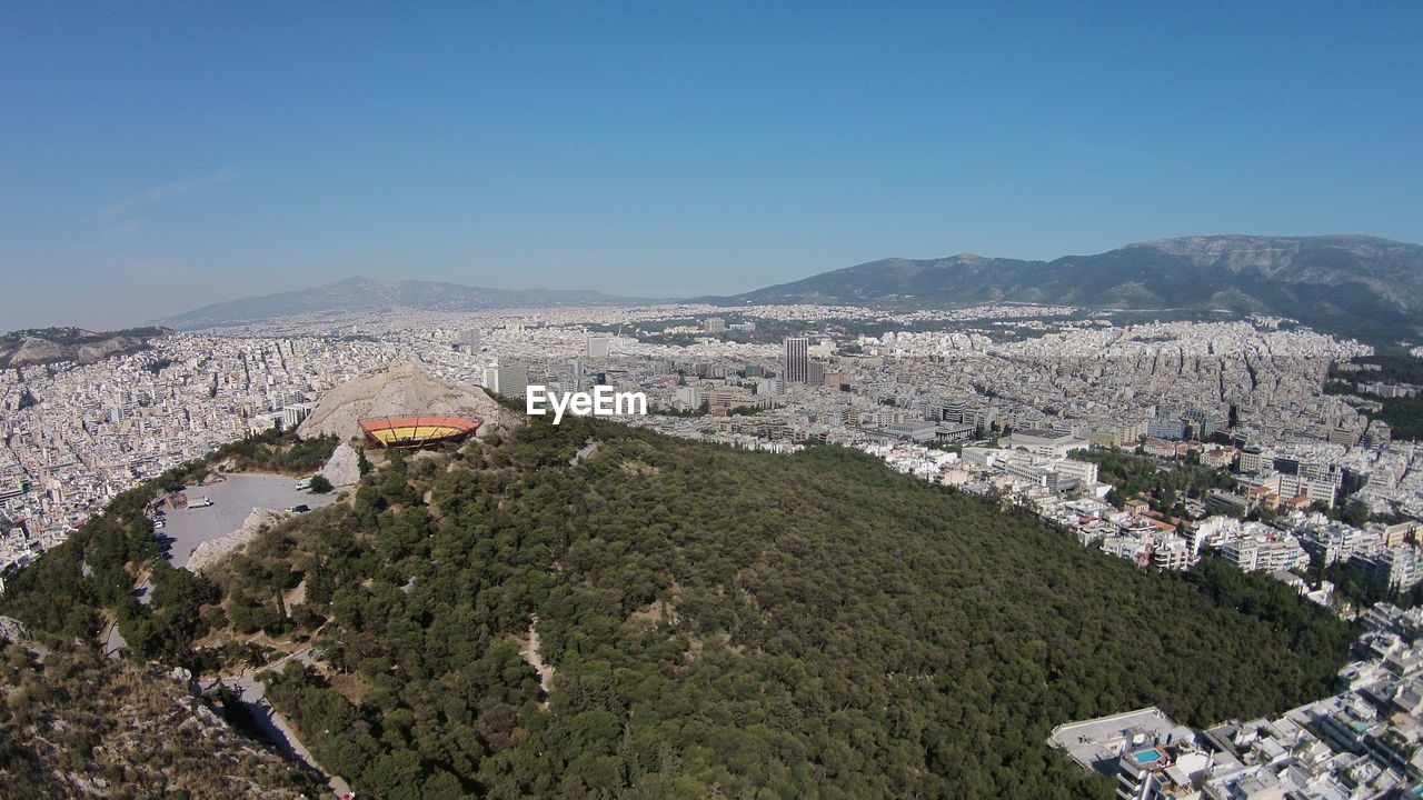 High angle view of cityscape against clear blue sky