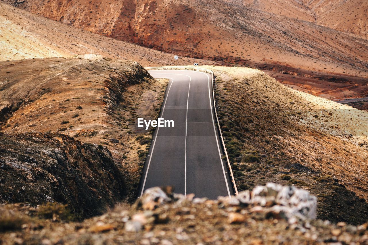 High angle view of empty road on mountains during sunny day