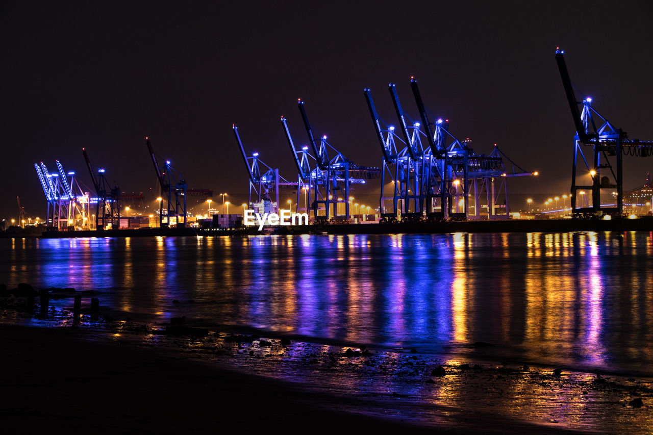 ILLUMINATED COMMERCIAL DOCK AT NIGHT