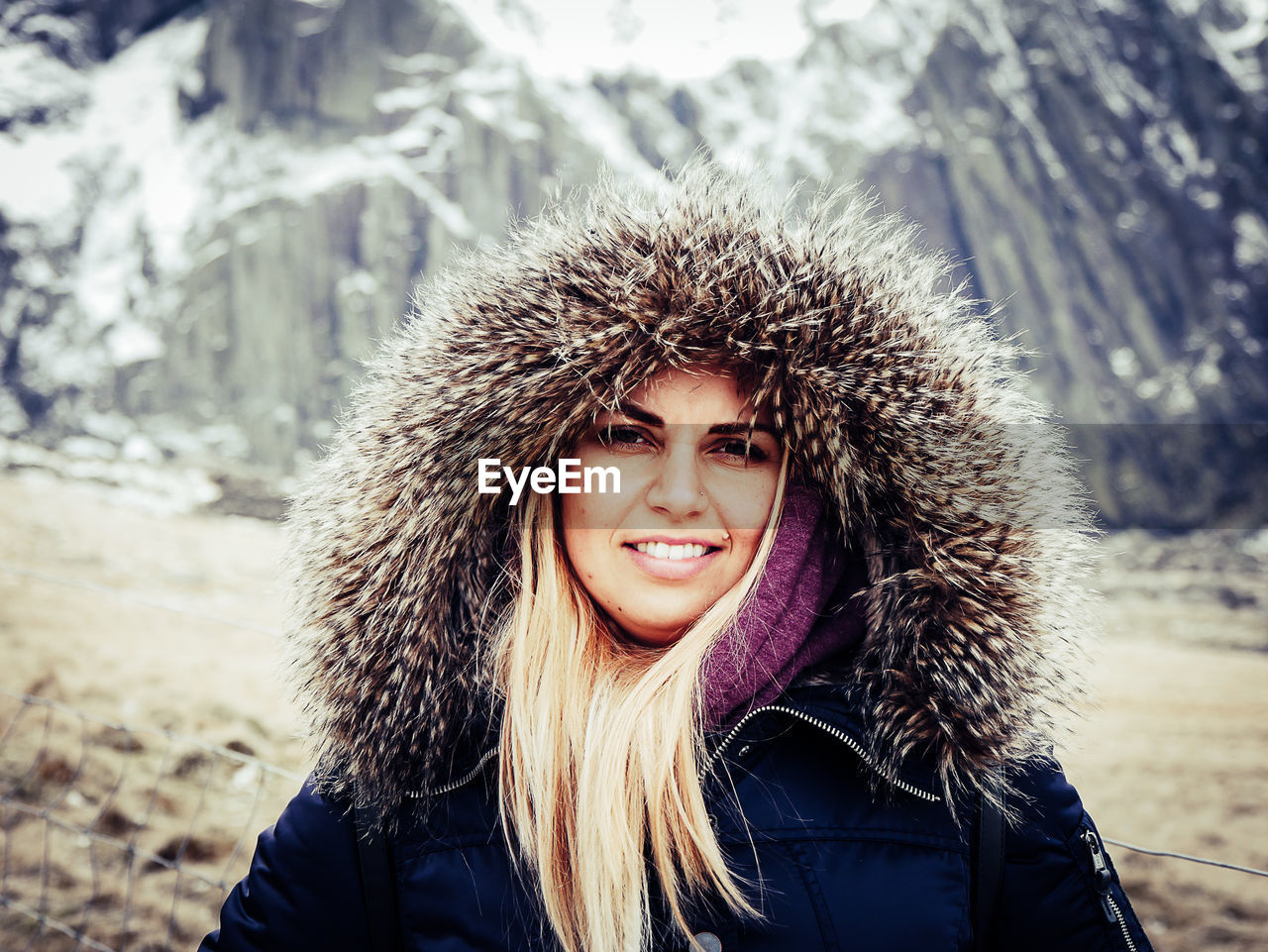 Portrait of young woman standing outdoors during winter