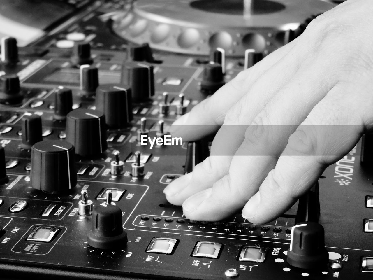 Cropped hand of dj playing sound mixer