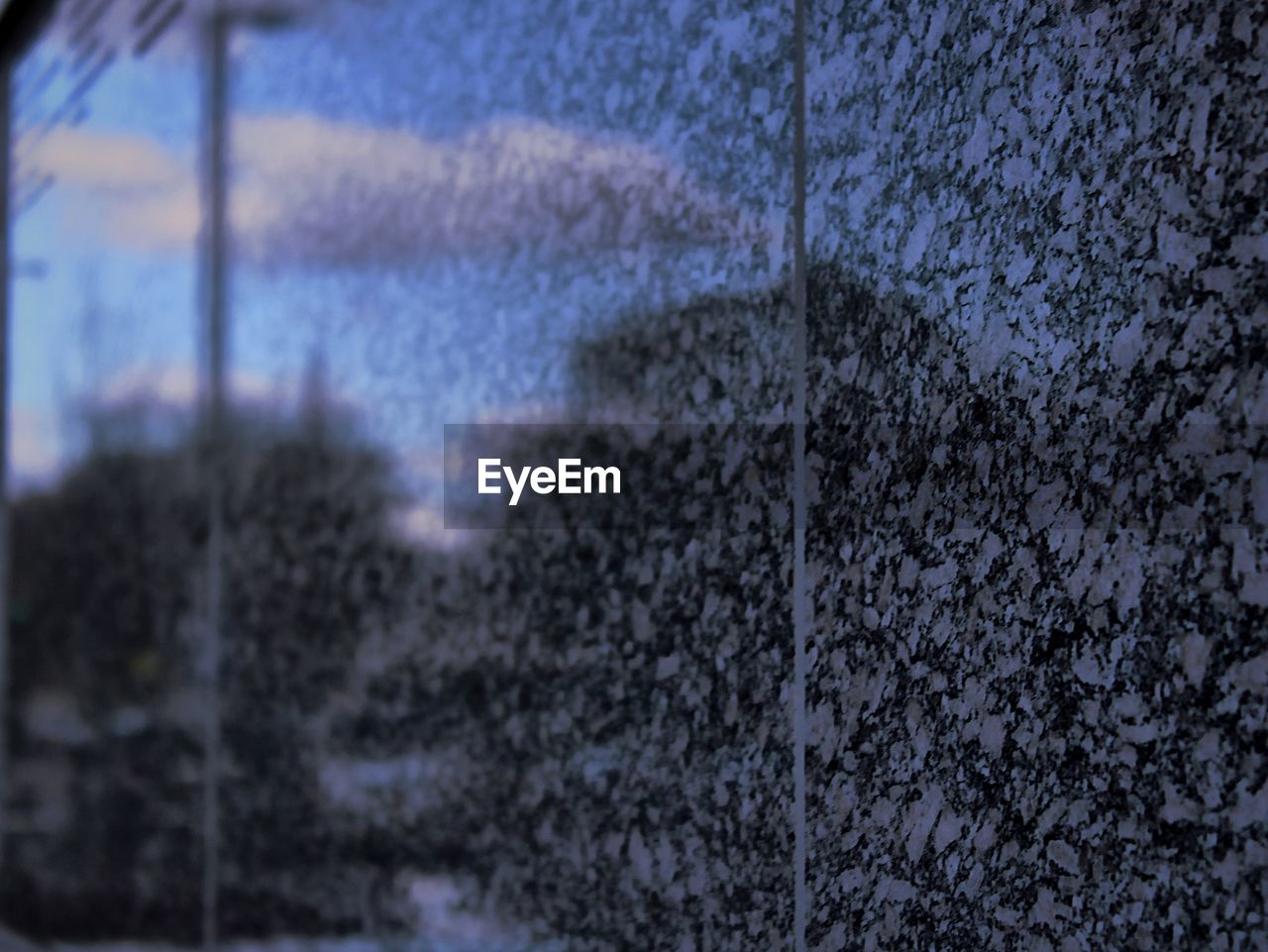 Reflection of sky on granite wall