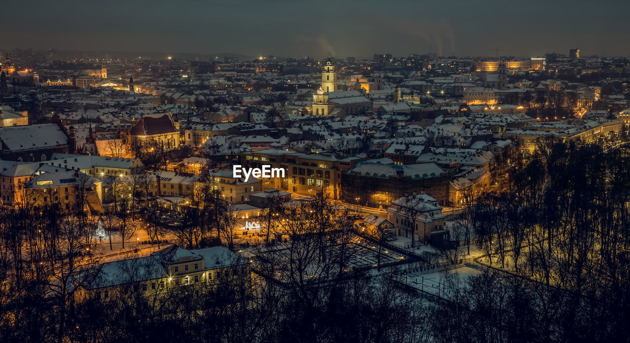 High angle view of illuminated cityscape against sky at dusk