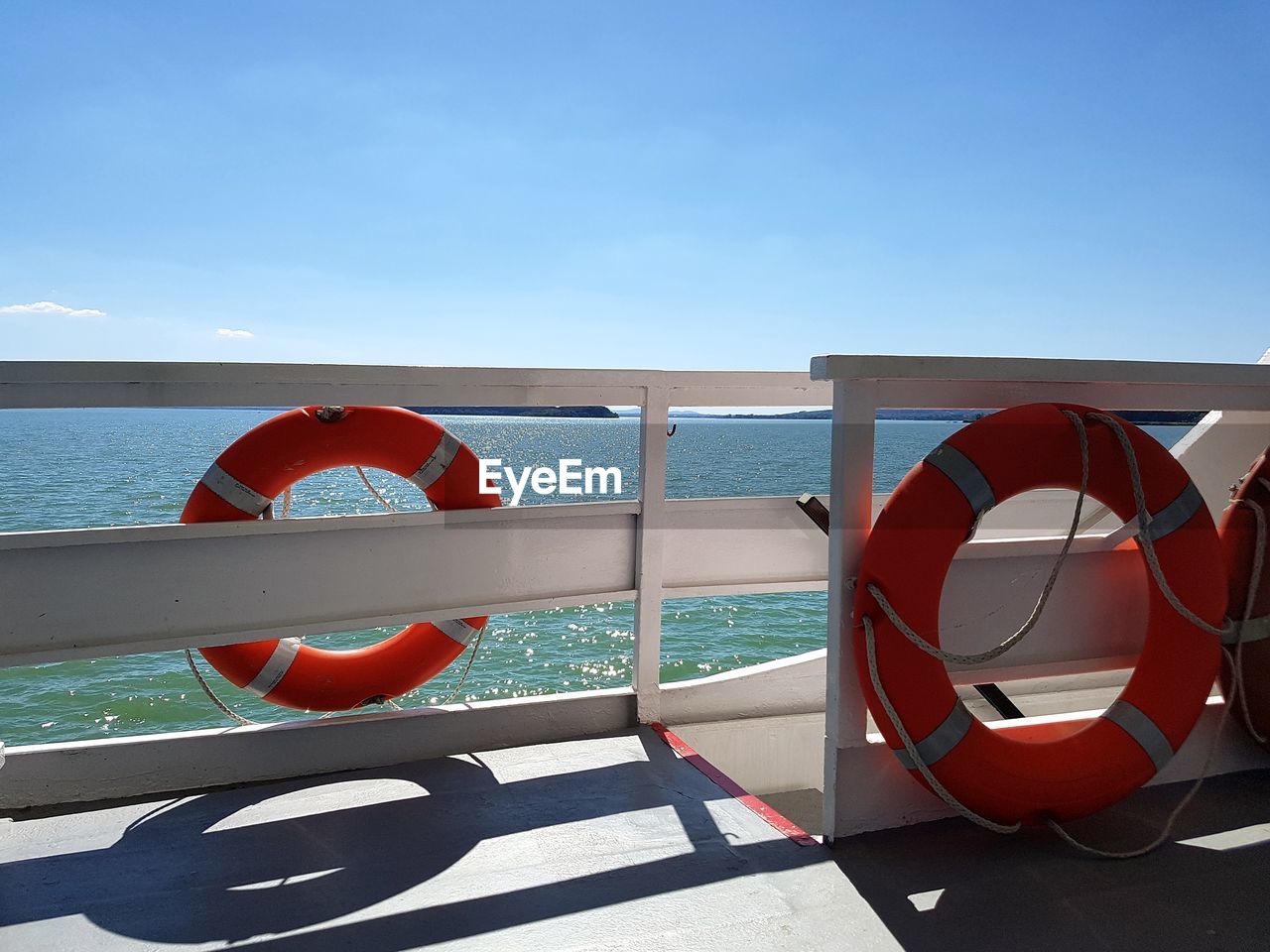 RAILING BY SEA AGAINST SKY