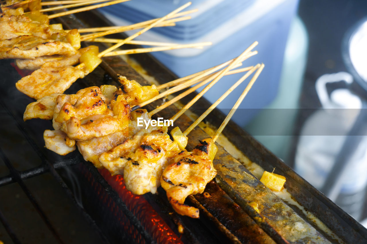 HIGH ANGLE VIEW OF MEAT COOKING ON BARBECUE