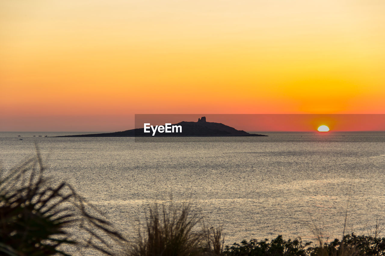 SCENIC VIEW OF SEA AGAINST ORANGE SKY