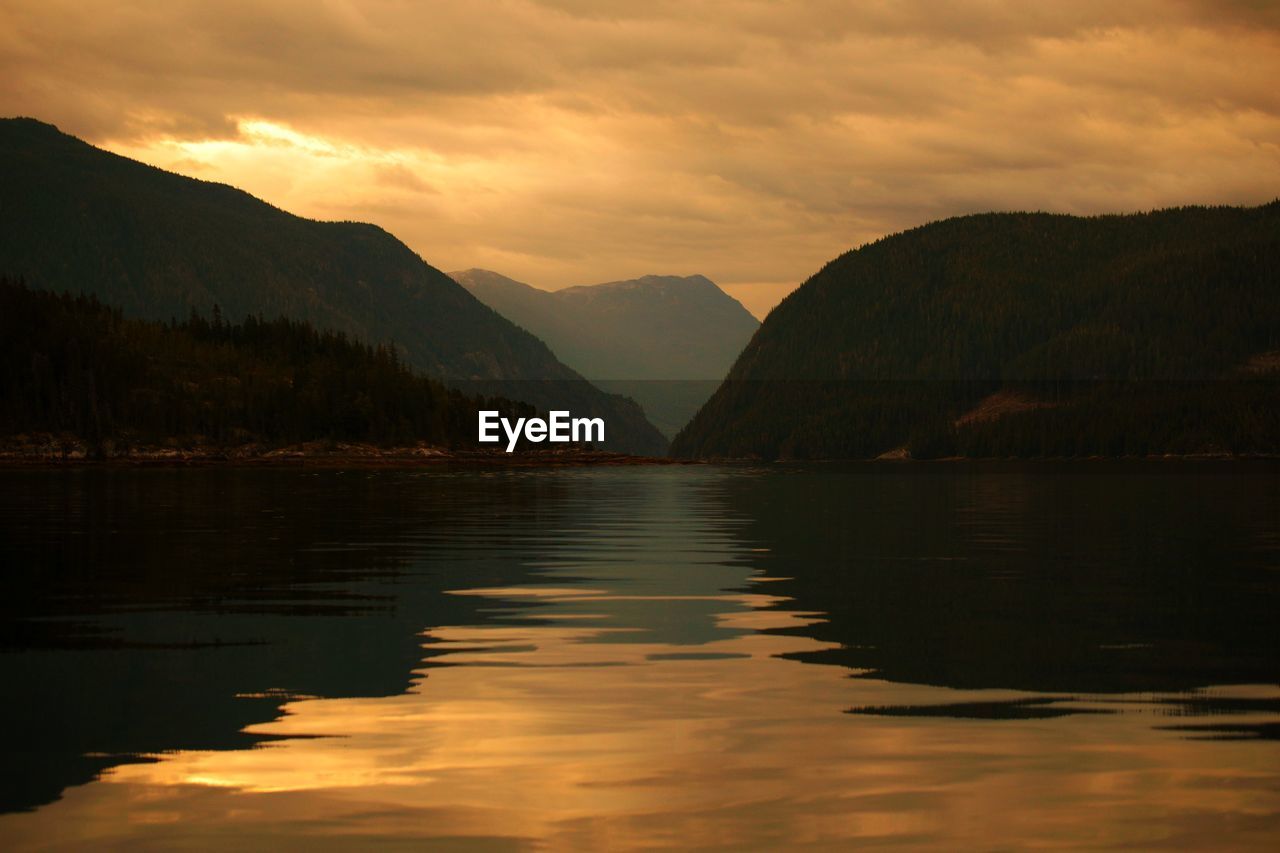 Scenic view of lake against sky during sunset