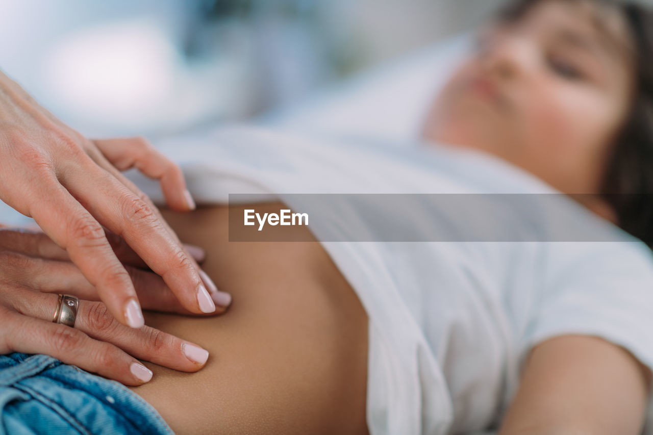 Pediatrician gastroenterologist, examining preschooler boys abdomen.