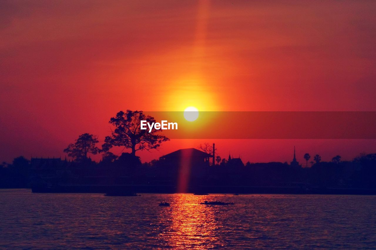 Scenic view of lake against romantic sky at sunset