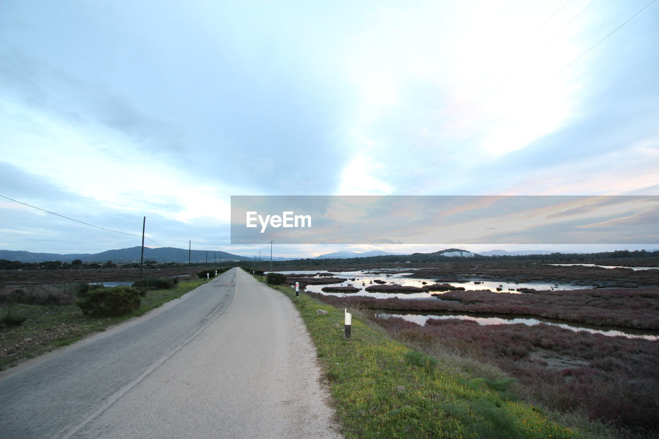 VIEW OF ROAD AGAINST CLOUDY SKY