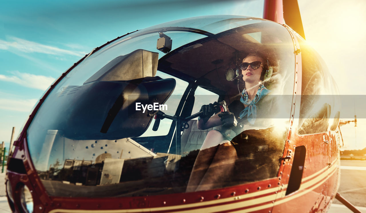 Woman in sunglasses inside helicopter