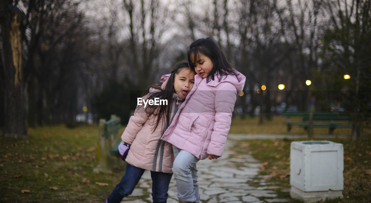 Sisters in park at dusk