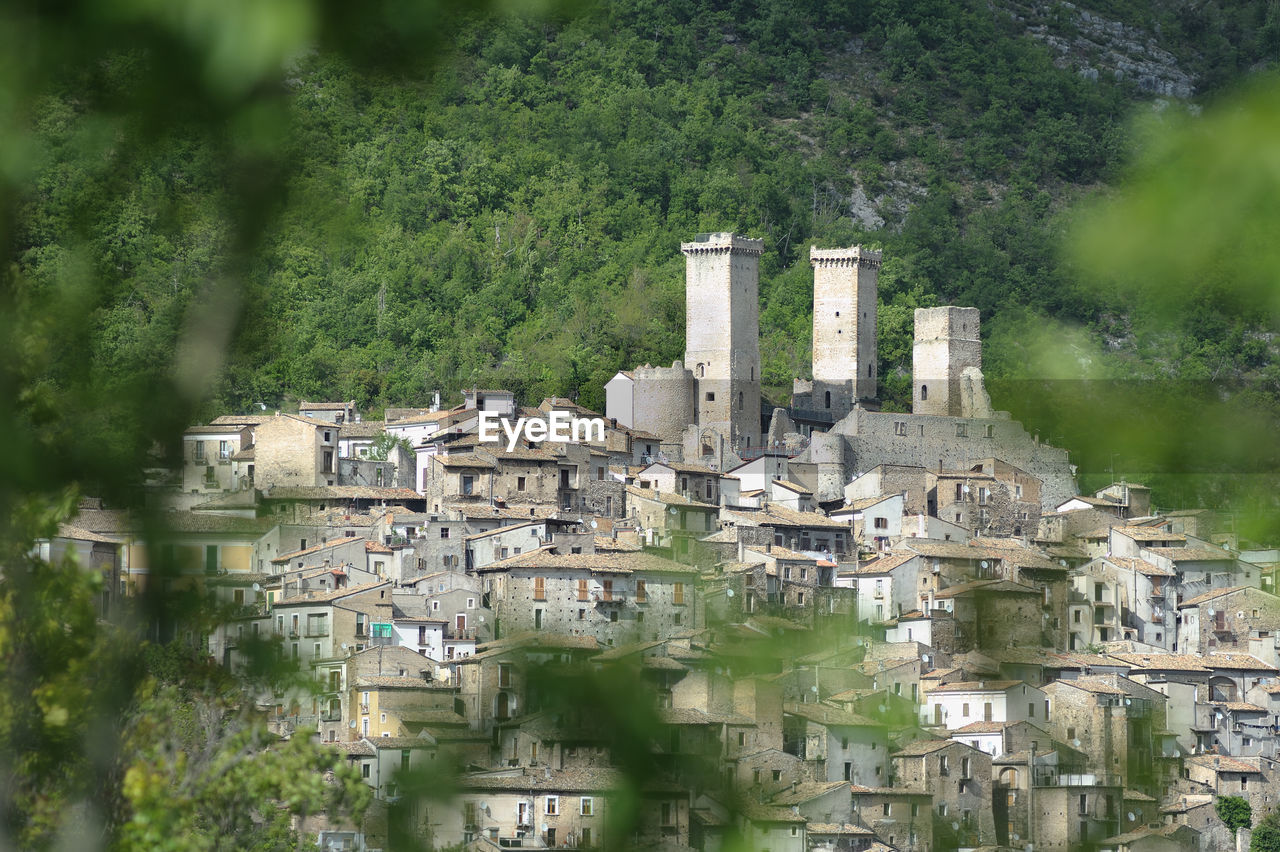 High angle view of buildings against mountain in town