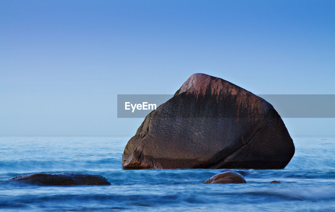 Scenic view of calm sea against clear sky