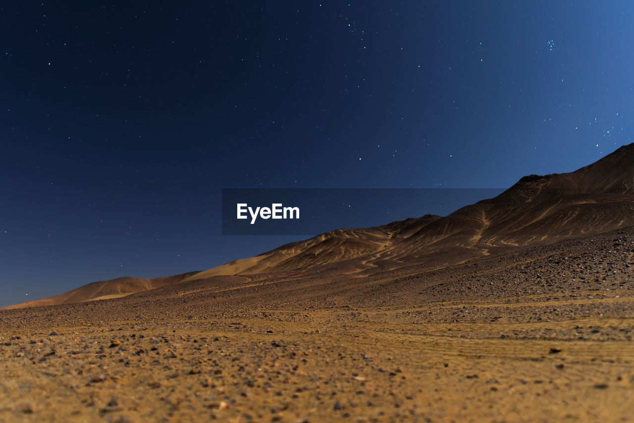 Low angle view of desert against sky at night